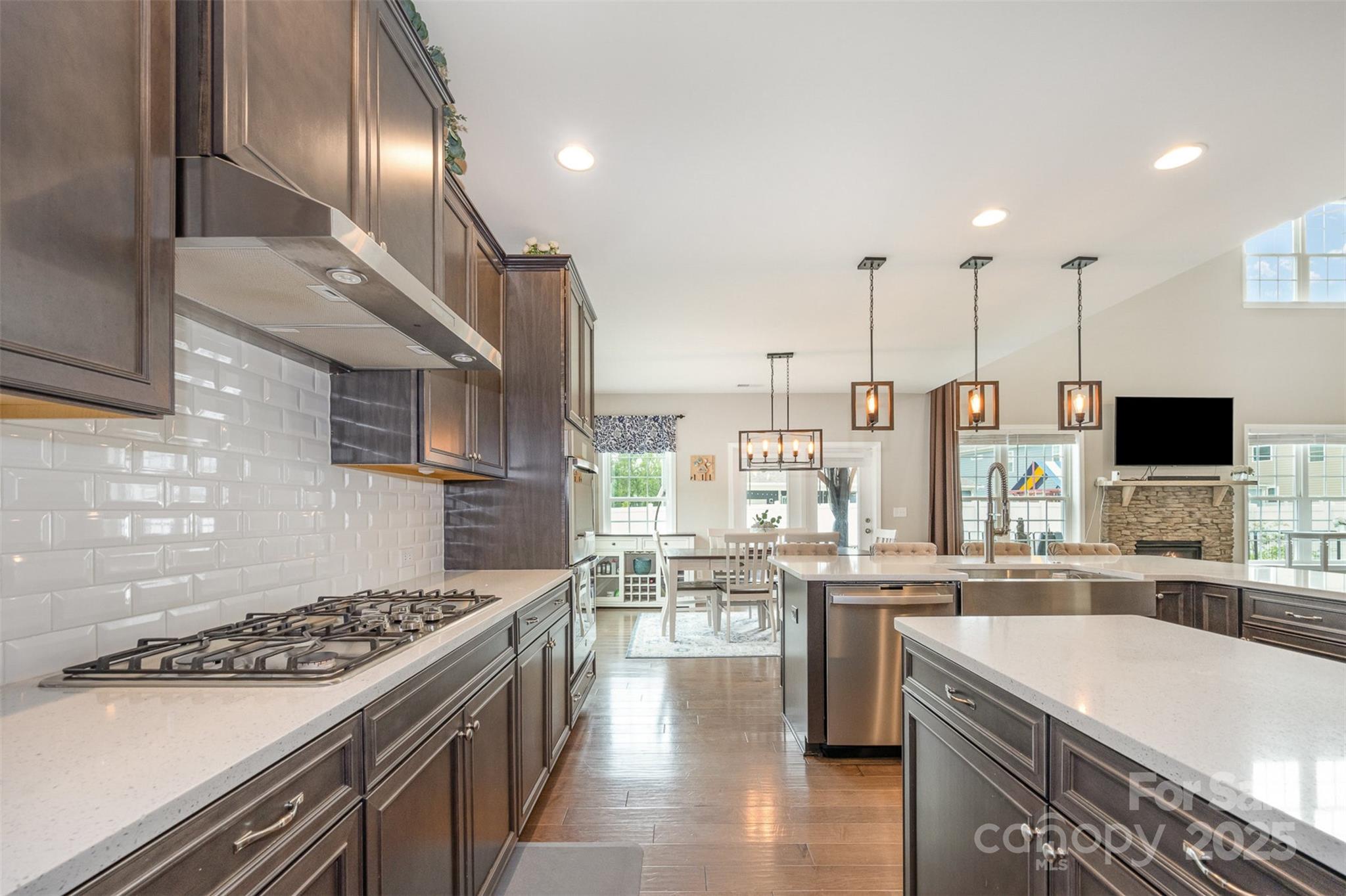 2960 Haley Circle Davidson, NC 28036 - Photo 4 of 31 a kitchen with stainless steel appliances granite countertop a sink stove and refrigerator