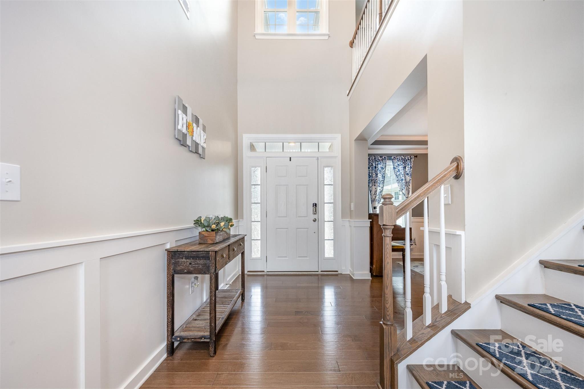2960 Haley Circle Davidson, NC 28036 - Photo 8 of 31 a hallway with wooden floor windows and stairs