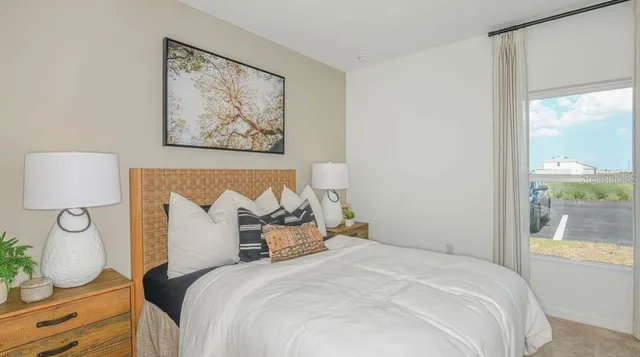 a bedroom with a bed and a window