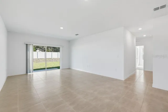 a view of a kitchen with a refrigerator and a stove top oven