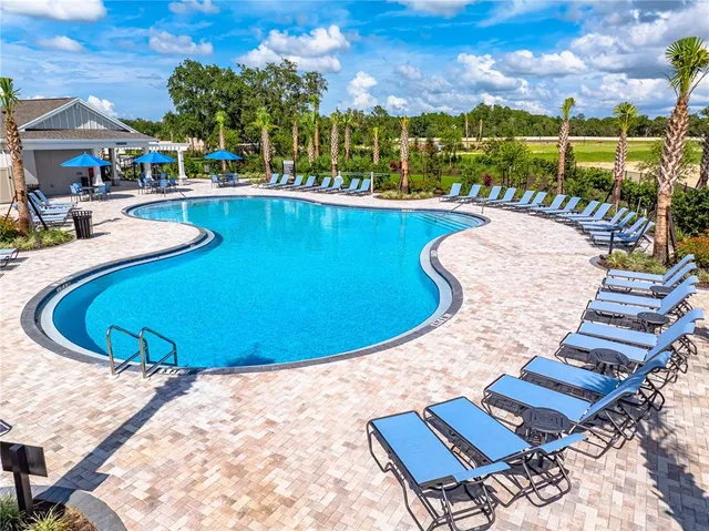 a view of a swimming pool with outdoor seating