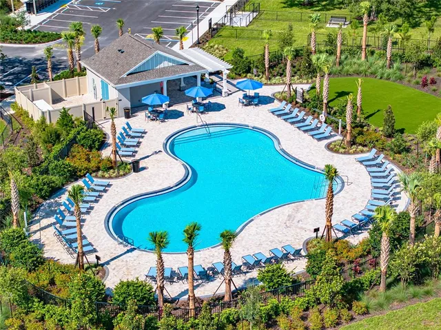 an aerial view of a swimming pool patio and outdoor seating