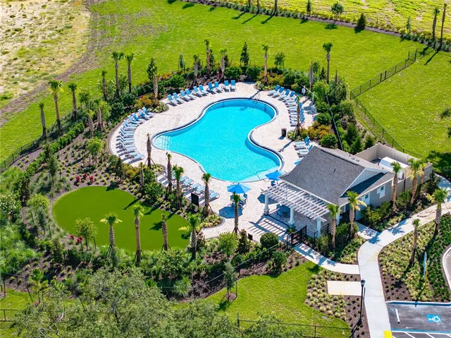 an aerial view of a house with a garden and lots of trees