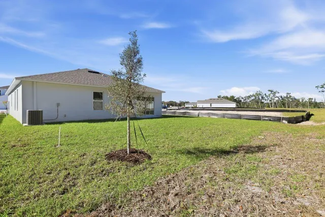 a backyard of a house with lots of green space and plants