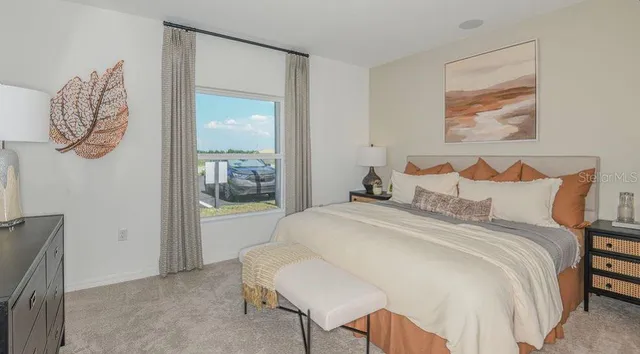 a bedroom with a bed and a painting on the wall