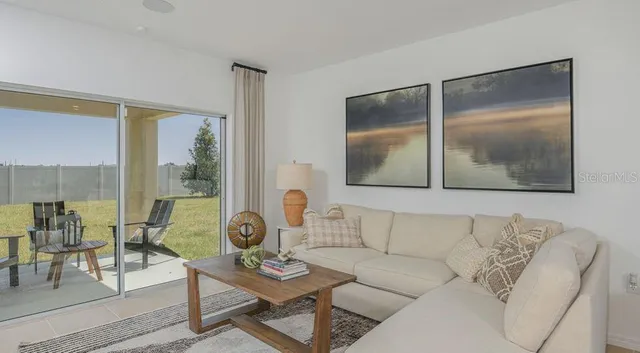 a living room with furniture and a large window