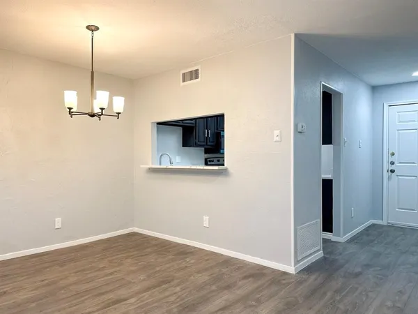 a view of a room with wooden floor and windows