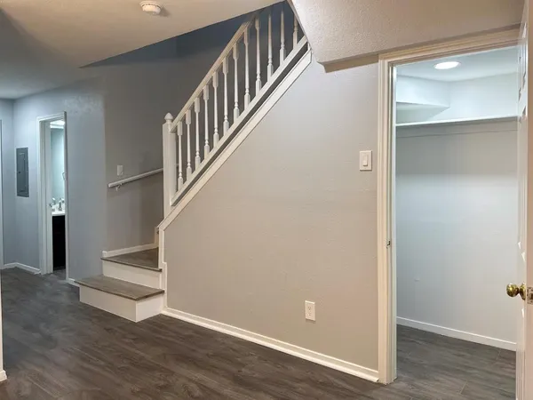 a view of an entryway with wooden floor and door