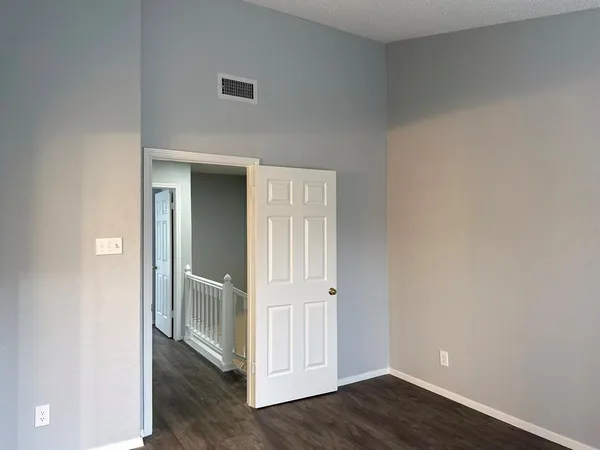 an empty room with wooden floor and closet