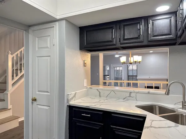 a kitchen with stainless steel appliances granite countertop a sink and a stove