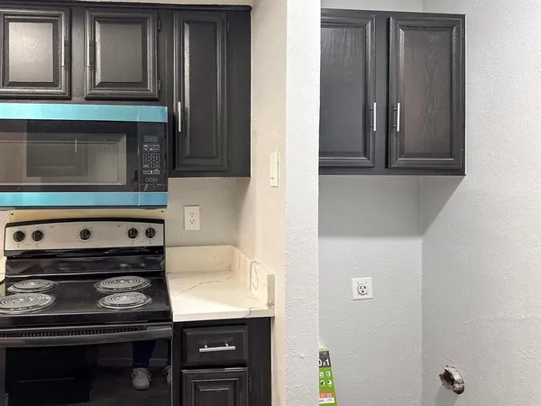 a kitchen with a stove and a microwave