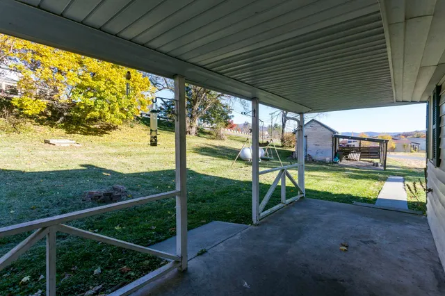 a view of a porch with furniture and backyard