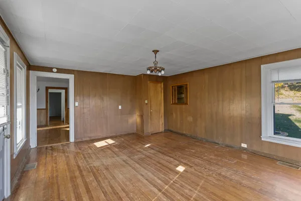wooden floor in an empty room with a window