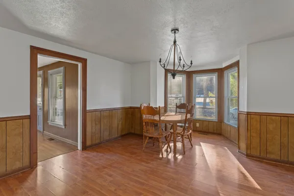a view of a dining room with furniture window and wooden floor