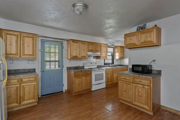 a kitchen with a stove top oven sink and cabinets
