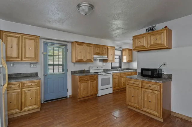 a kitchen with a stove top oven sink and cabinets