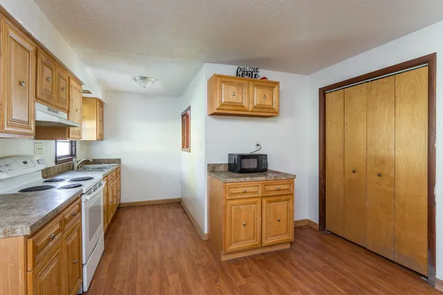 a kitchen with stainless steel appliances granite countertop a stove and a sink