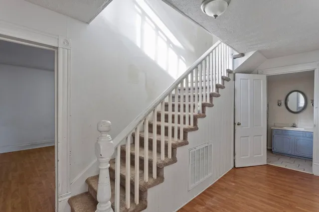 a view of entryway and hall with wooden floor