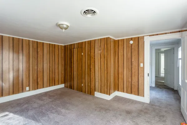 a view of a room with a ceiling fan and window
