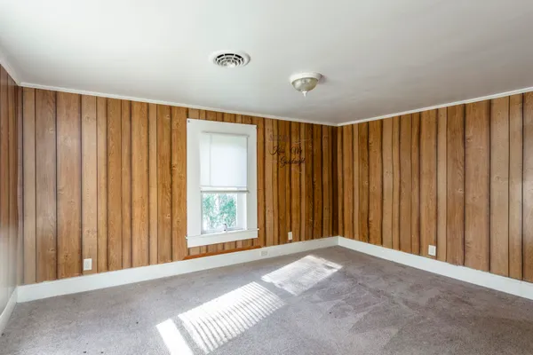an empty room with windows and closet
