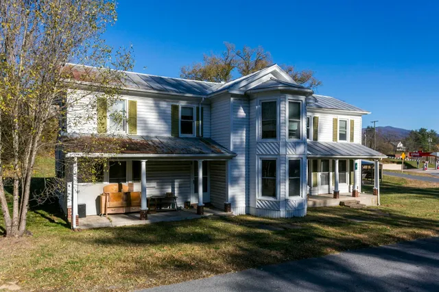 a front view of a residential apartment building with a yard