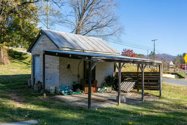 a view of a house with backyard porch and sitting area