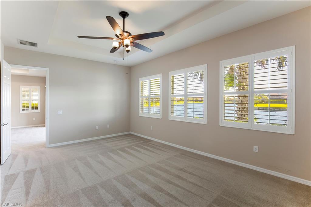 13515 Cambridge Lane Naples, FL 34109 - Photo 12 of 28 wooden floor in an empty room with a window