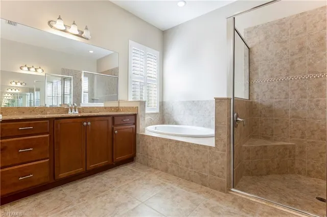 a bathroom with a granite countertop sink a toilet and a bathtub