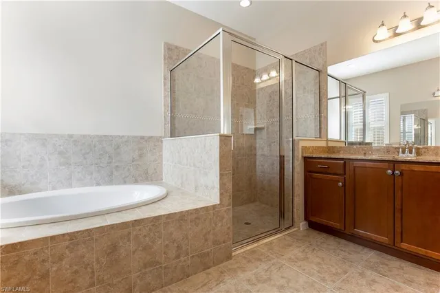 a bathroom with a granite countertop sink a toilet and shower