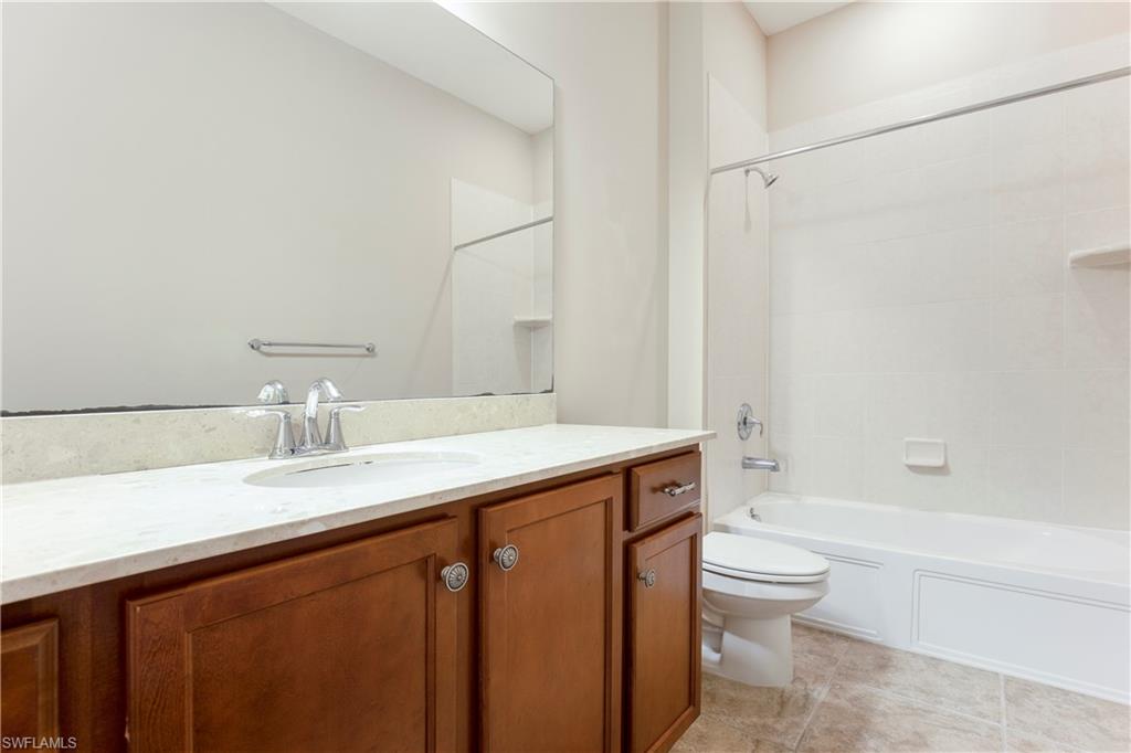 13515 Cambridge Lane Naples, FL 34109 - Photo 20 of 28 a bathroom with a sink a toilet and shower