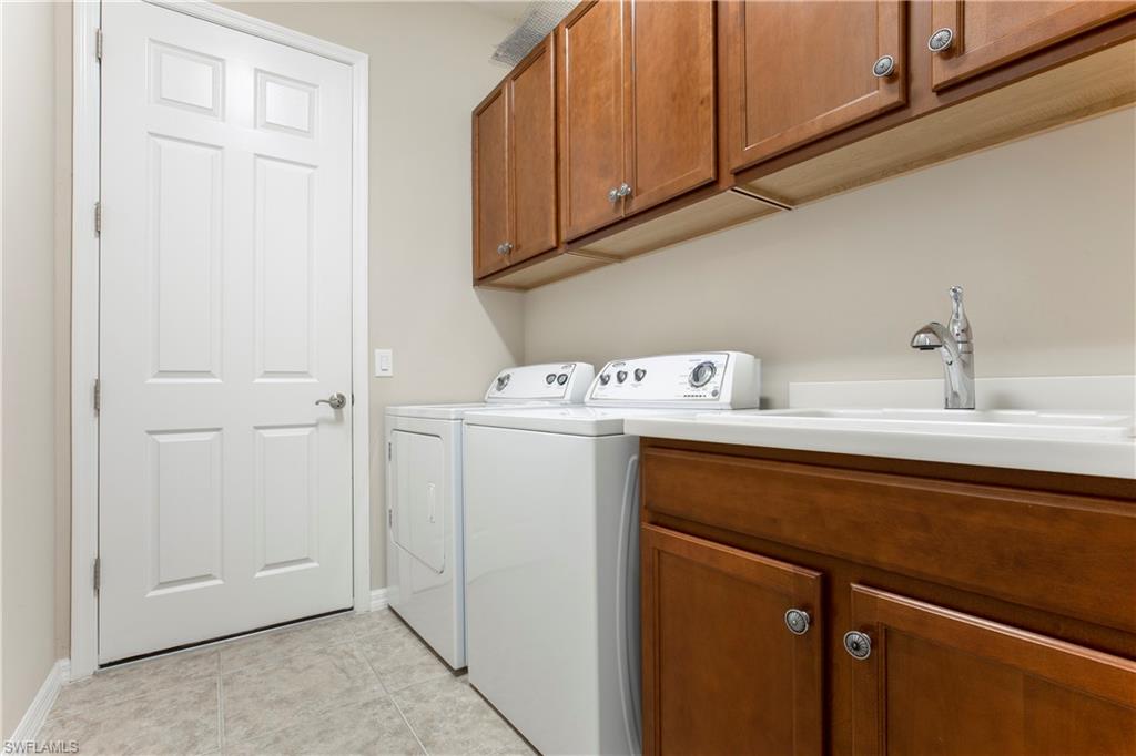 13515 Cambridge Lane Naples, FL 34109 - Photo 21 of 28 a utility room with dryer and washer