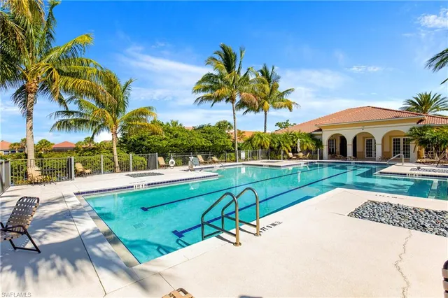 a view of swimming pool with a garden and trees