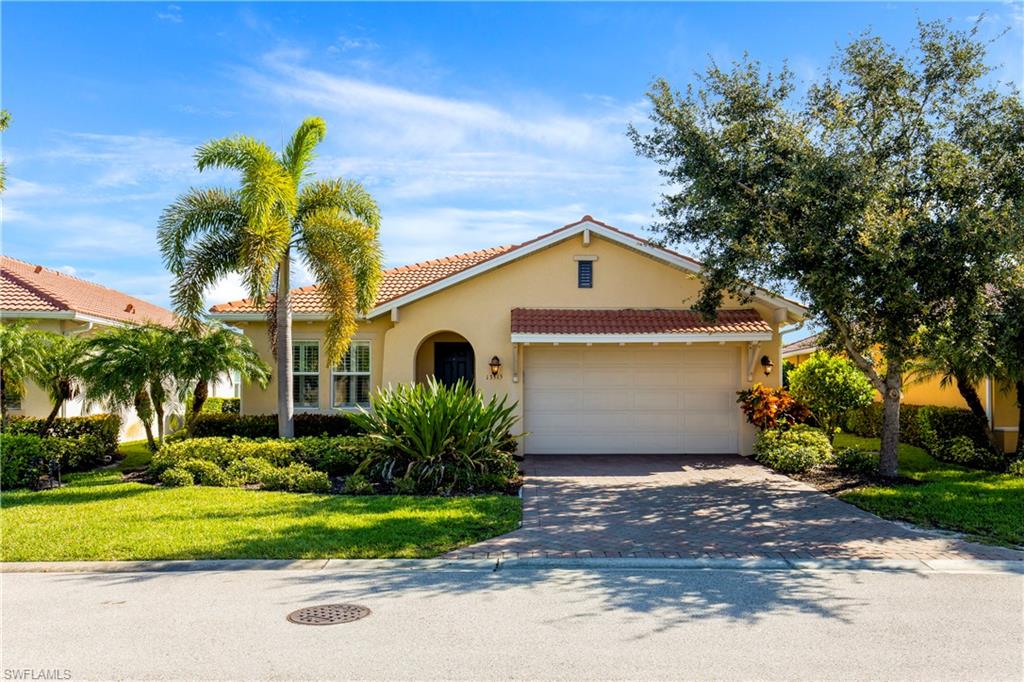 13515 Cambridge Lane Naples, FL 34109 - Photo 27 of 28 a front view of house with yard and green space