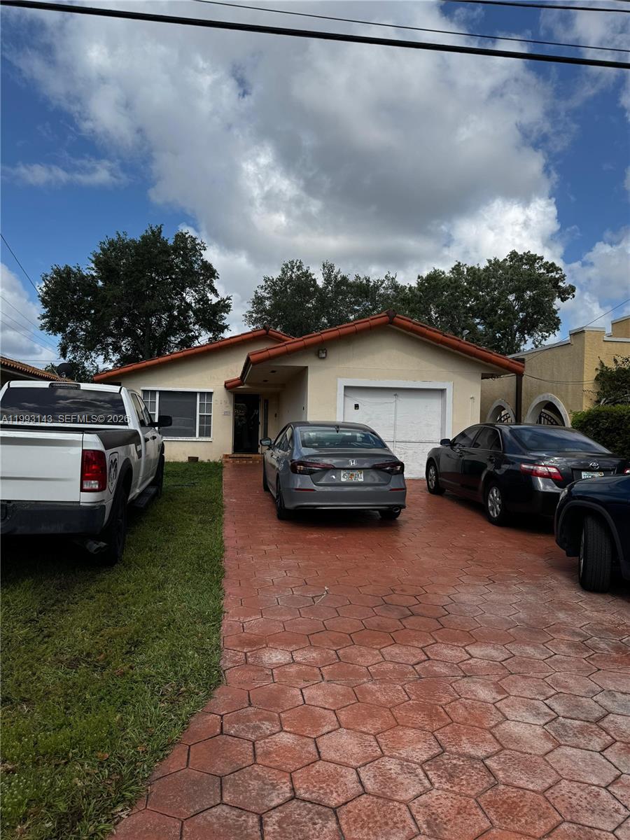 2194 Southwest 57th Court, Unit 2194 Miami, FL 33155 - Photo 4 of 10 a couple of cars parked in front of a house