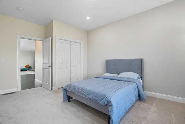 a bedroom with a bed and a mirror