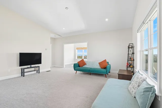 a bedroom with furniture and a flat screen tv