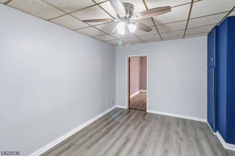 36 Edison Street Bloomfield, NJ 07003 - Photo 11 of 28 a view of a room with wooden floor and a ceiling fan