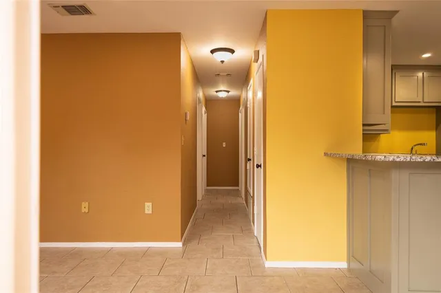 a view of a hallway with a bathroom