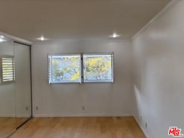 an empty room with windows and closet