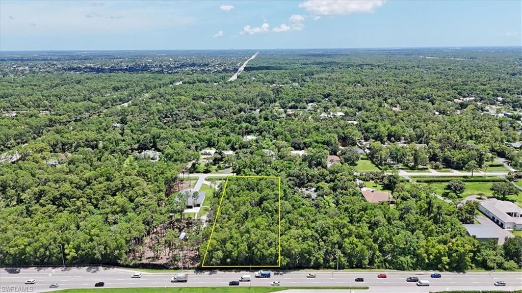 5665 Napa Woods Way Naples, FL 34116 - Photo 11 of 20 an aerial view of a house with a yard