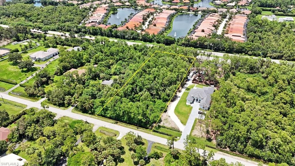 5665 Napa Woods Way Naples, FL 34116 - Photo 5 of 20 an aerial view of residential houses with outdoor space and trees all around