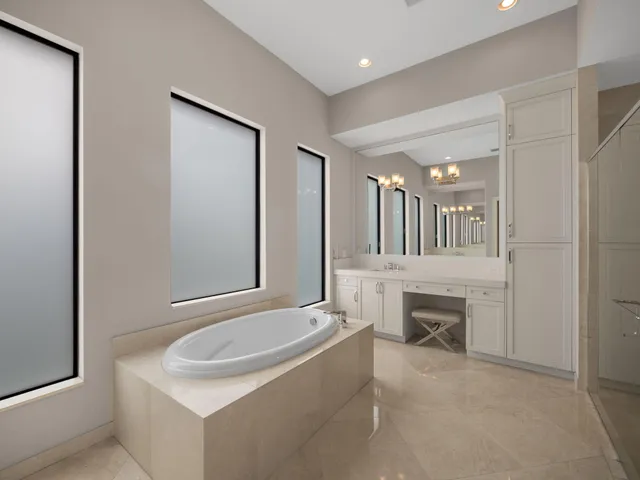a bathroom with a tub sink and mirror