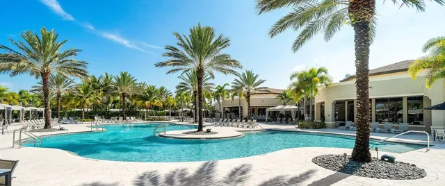 a view of a fountain with palm trees