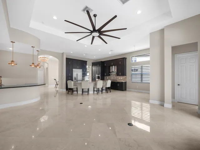 a view of a livingroom with furniture and a ceiling fan