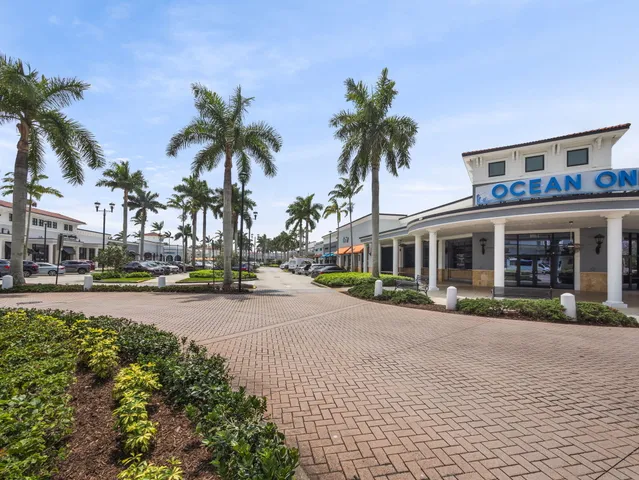 a front view of multiple houses with yard