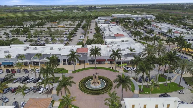 a view of a city with lawn chairs and large trees