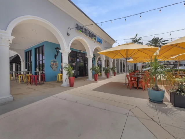 a group of people sitting under an umbrella