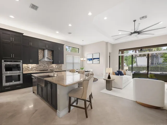 a large kitchen with a large window and stainless steel appliances