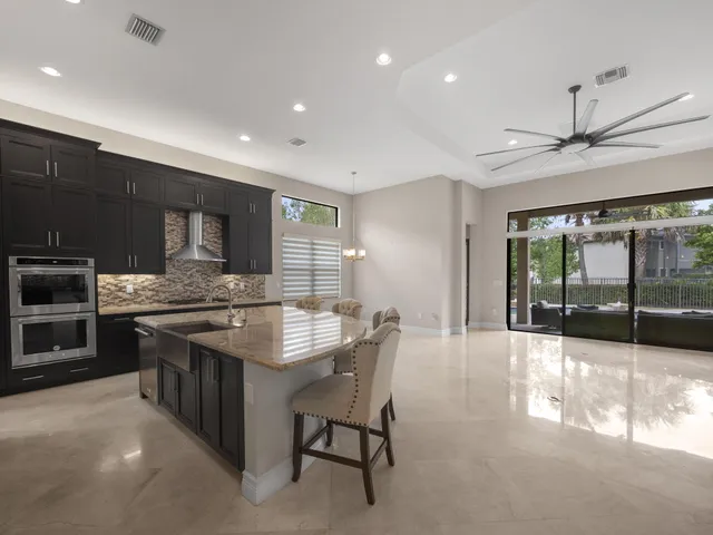 a kitchen with stainless steel appliances granite countertop a stove and a sink