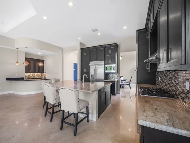 a kitchen with stainless steel appliances granite countertop lots of counter top space